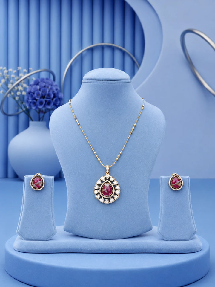Teardrop Stone Pendant Set with pink center stone and matching gold-toned earrings