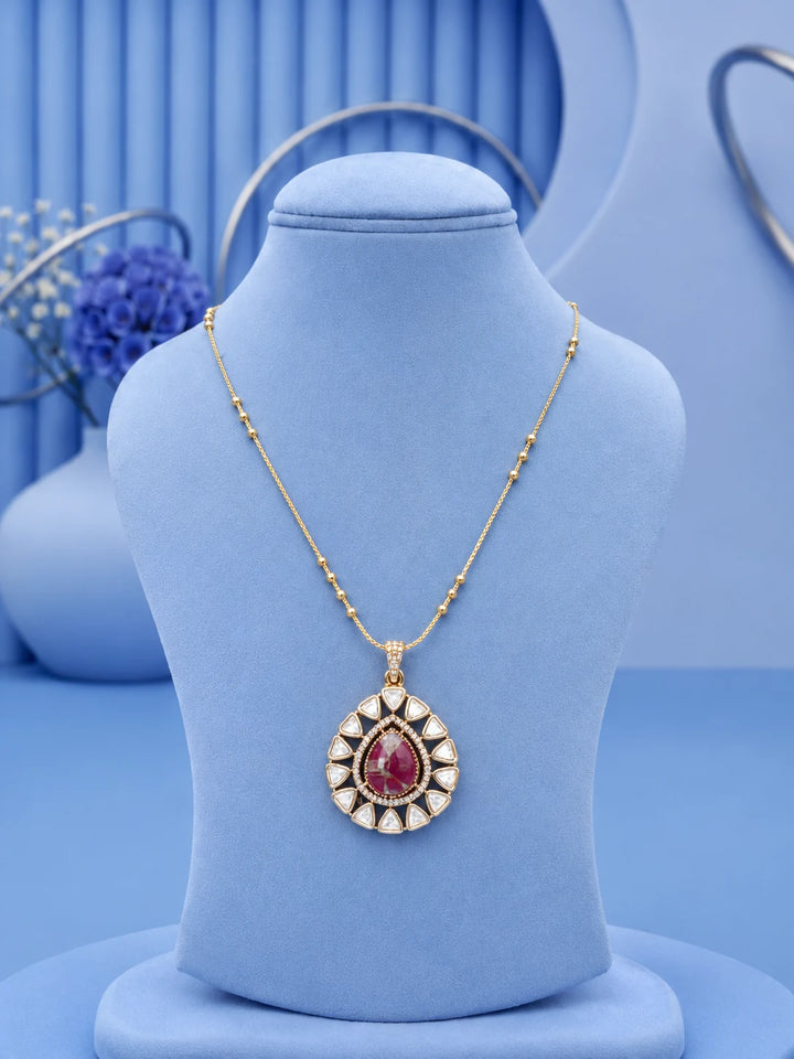Teardrop Stone Pendant Set with pink center stone and matching gold-toned earrings