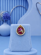 Teardrop Stone Pendant Set with pink center stone and matching gold-toned earrings