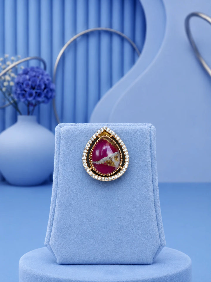 Teardrop Stone Pendant Set with pink center stone and matching gold-toned earrings