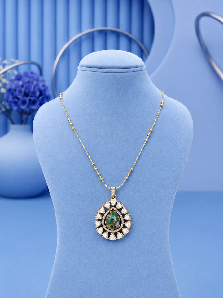 Teardrop Stone Pendant Set with green center stone and matching gold-toned earrings