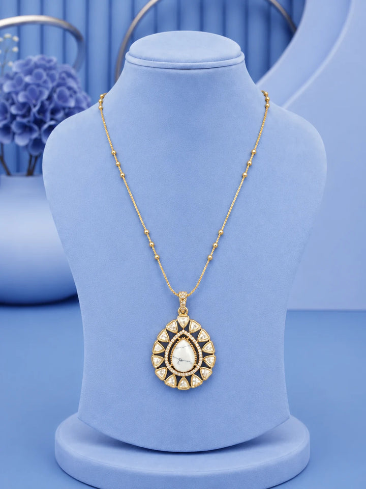 Teardrop Stone Pendant Set with white stone pendant and matching gold-toned earrings