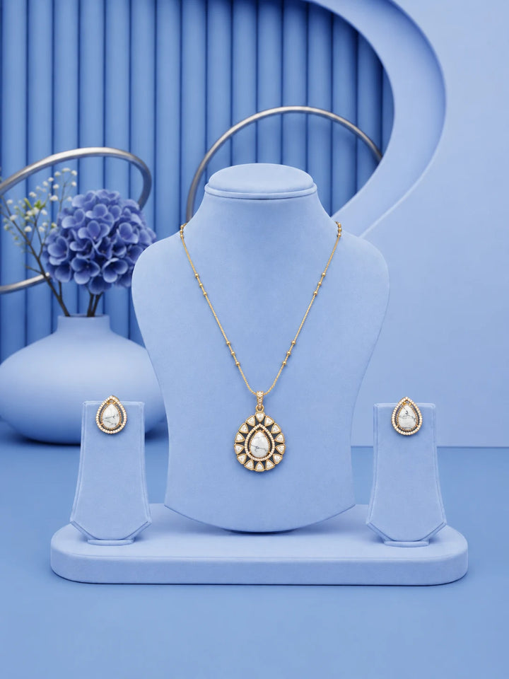 Teardrop Stone Pendant Set with white stone pendant and matching gold-toned earrings