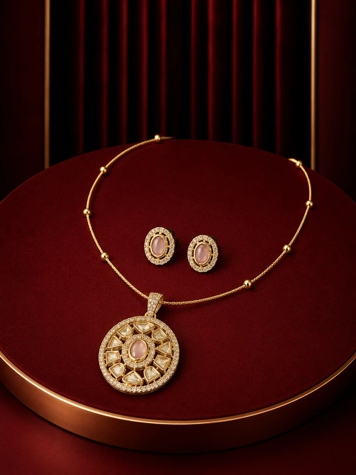 Round Pendant Necklace Set with pink oval center stone, circular gold-toned pendant, crystal detailing, and matching studs