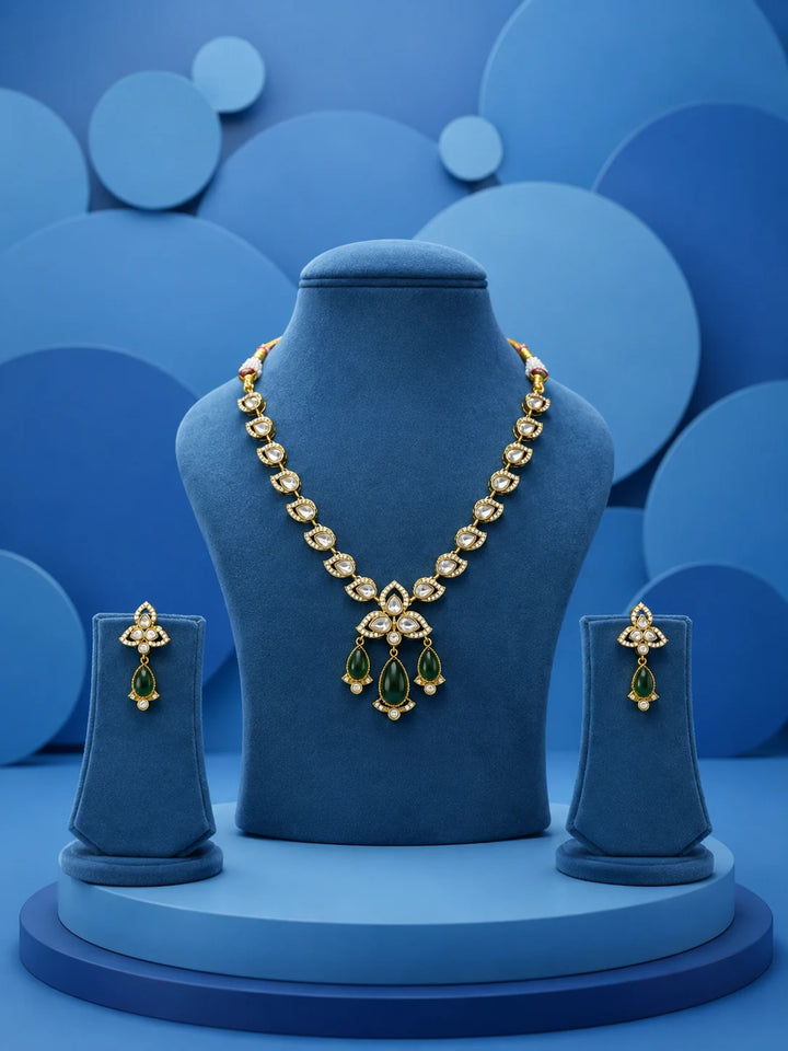 Kundan Drop Necklace Set with green teardrop drops, white kundan-style stones, gold-toned necklace, and matching earrings