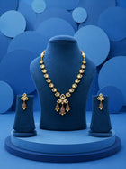 Kundan Drop Necklace Set with green teardrop drops, white kundan-style stones, gold-toned necklace, and matching earrings