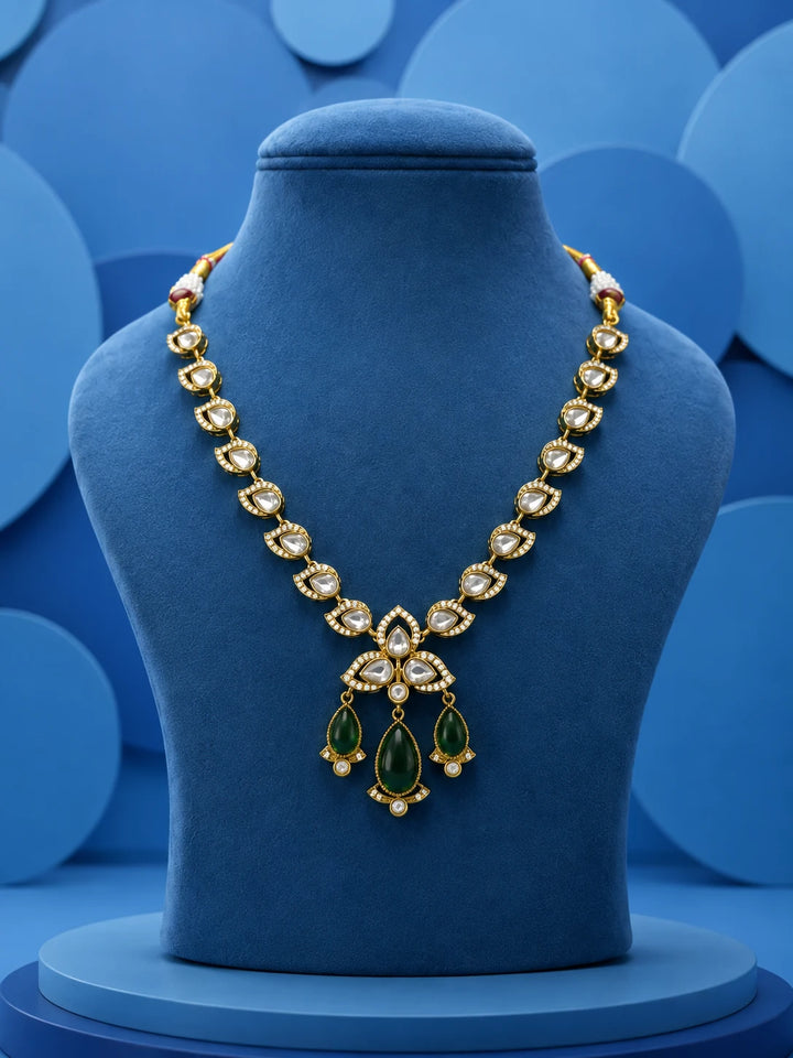 Kundan Drop Necklace Set with green teardrop drops, white kundan-style stones, gold-toned necklace, and matching earrings