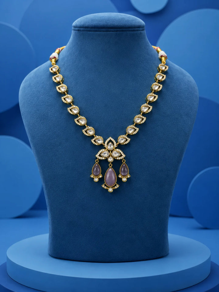 Kundan Drop Necklace Set with green teardrop drops, white kundan-style stones, gold-toned necklace, and matching earrings