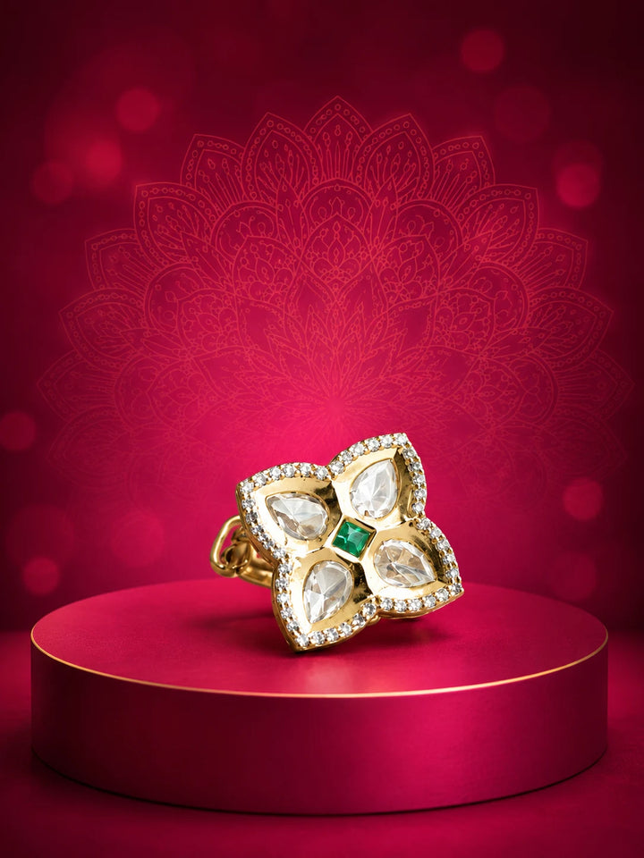 Floral Kundan Ring with green square center stone, gold-toned four-petal design, white kundan-style stones, and crystal border