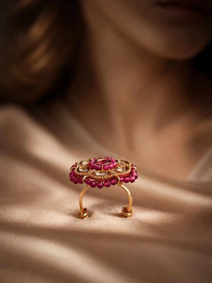 Beaded Kundan Ring with red bead border, gold-toned round design, red center stone, white kundan-style stones, and crystal accents