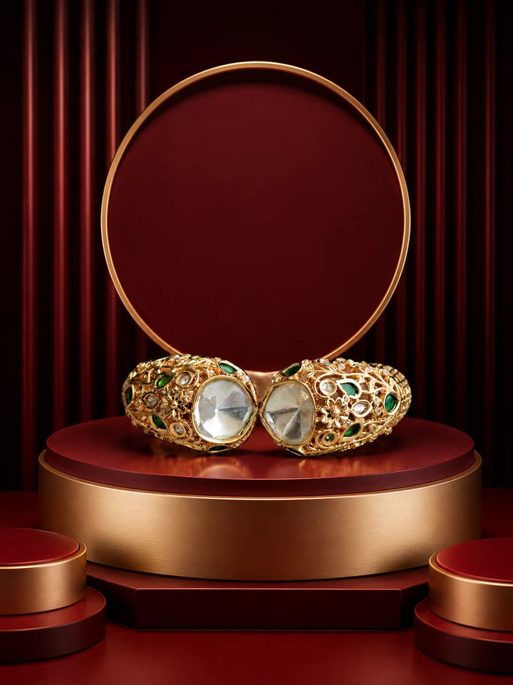 Green Kundan Kada with gold-toned floral cutwork, green stone accents, white kundan-style stones, and broad bracelet design