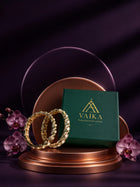 Green Kundan Bangles with gold-toned kada design, white kundan-style stones, green meenakari accents, and linked oval motifs