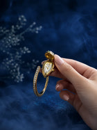 Bracelet Watch with gold-toned bangle, hidden analog dial, crystal-studded cover, and clear stone detailing