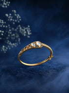 Kundan Stone Bracelet with gold-toned kada design, red accent stones, white kundan-style stones, and crystal detailing