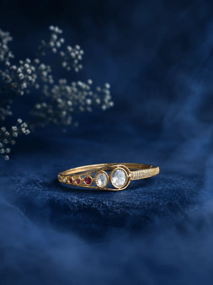 Kundan Stone Bracelet with gold-toned kada design, red accent stones, white kundan-style stones, and crystal detailing