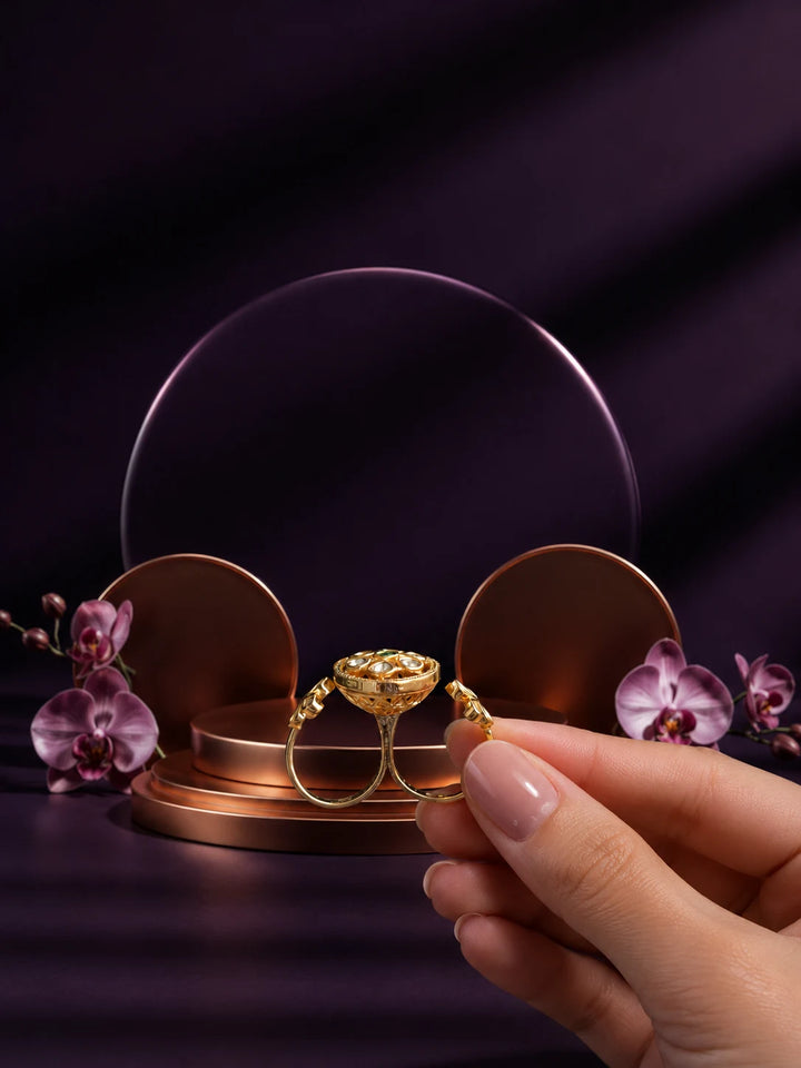 Floral Kundan Ring with green center stone, gold-toned two-finger design, white kundan-style accents, and floral side details