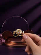 Floral Kundan Ring with green center stone, gold-toned two-finger design, white kundan-style accents, and floral side details