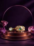 Kundan Two Finger Ring with green center stone, gold-toned statement design, white kundan-style stones, and round side motif