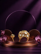 Kundan Two Finger Ring with green center stone, gold-toned statement design, white kundan-style stones, and round side motif