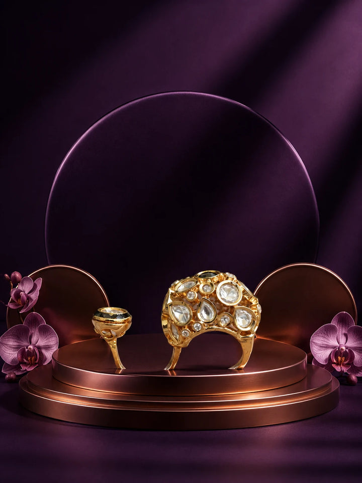 Kundan Two Finger Ring with green center stone, gold-toned statement design, white kundan-style stones, and round side motif