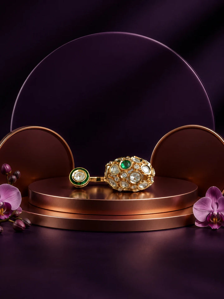 Kundan Two Finger Ring with green center stone, gold-toned statement design, white kundan-style stones, and round side motif
