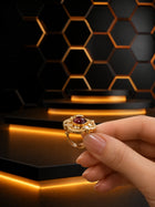 Red Kundan Ring with gold-toned round design, oval red center stone, white kundan-style accents, and ornate detailing