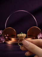 Green Kundan Ring with gold-toned round design, green center stone, white kundan-style accents, and crystal detailing