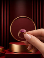 Pink Crystal Ring with gold-toned band, pavé-style magenta crystal top, and clear side accents