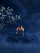 Red Stone Ring with square red center stone, gold-toned band, and clear crystal-style side accents