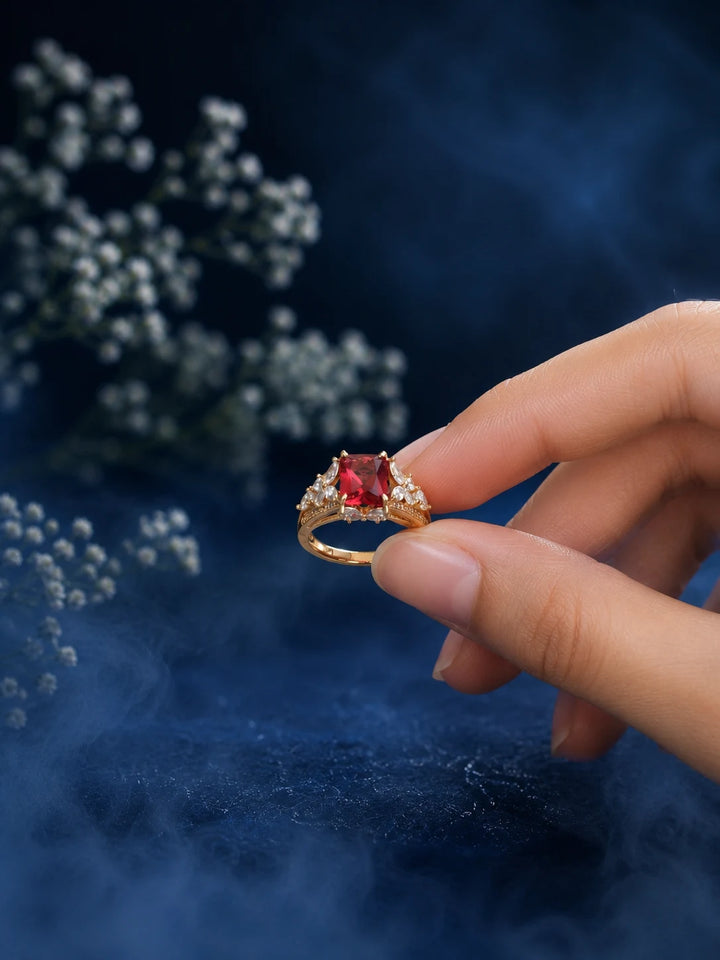 Red Stone Ring with square red center stone, gold-toned band, and clear crystal-style side accents