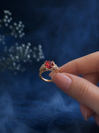 Red Stone Ring with square red center stone, gold-toned band, and clear crystal-style side accents